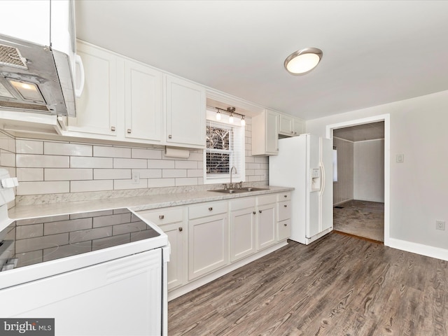 kitchen with dark wood finished floors, light countertops, white cabinetry, a sink, and white appliances