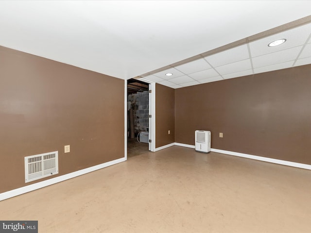 empty room featuring baseboards, visible vents, concrete flooring, a paneled ceiling, and recessed lighting