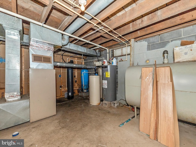 unfinished below grade area featuring concrete block wall and water heater