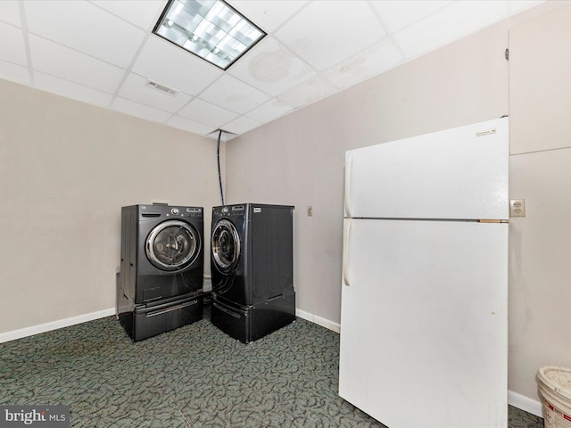 clothes washing area with laundry area, carpet floors, visible vents, baseboards, and washer and clothes dryer