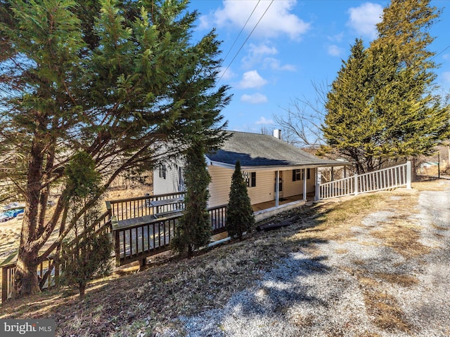 rear view of house with roof with shingles and fence