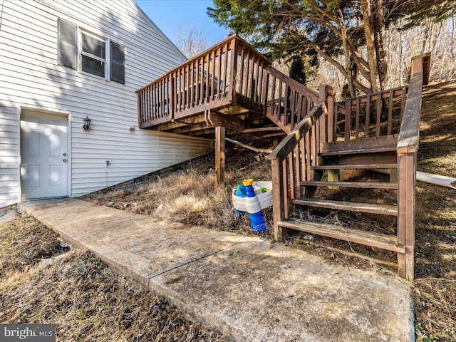 view of property exterior featuring a deck and stairway