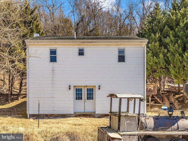 rear view of house with stairs and french doors