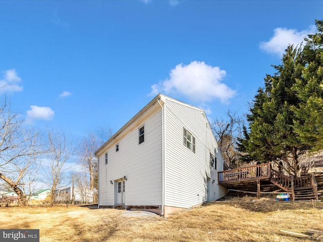 view of side of property featuring a wooden deck