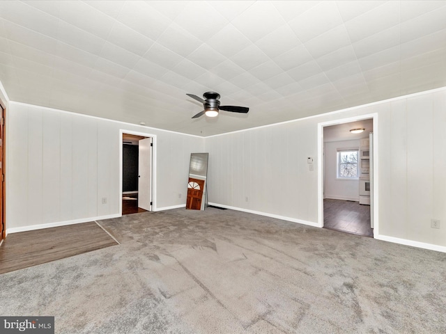 interior space featuring baseboards and a ceiling fan