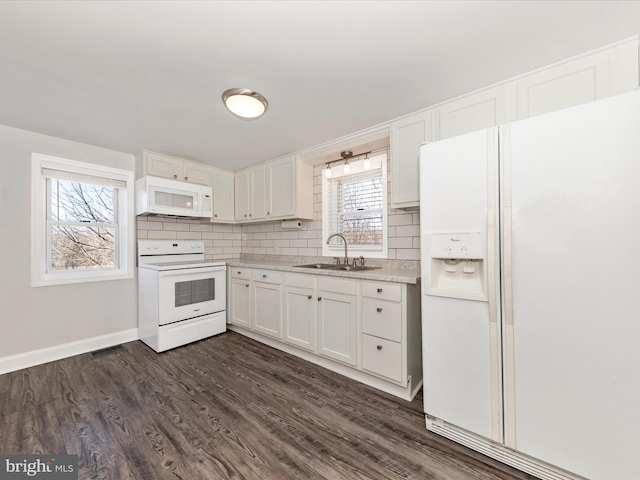 kitchen with white appliances, white cabinets, light countertops, backsplash, and dark wood finished floors