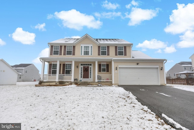 view of front facade with a porch, driveway, and an attached garage