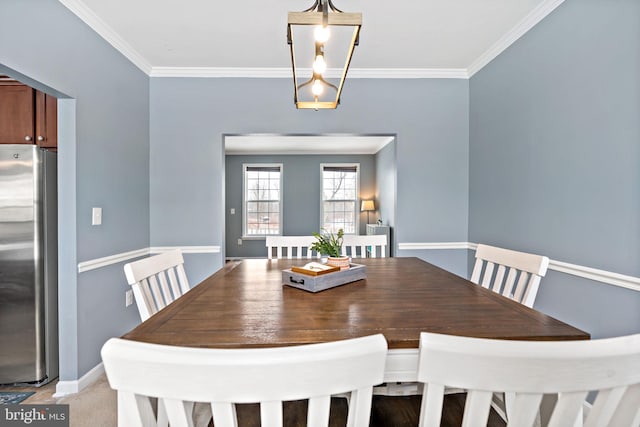 dining room with crown molding and baseboards