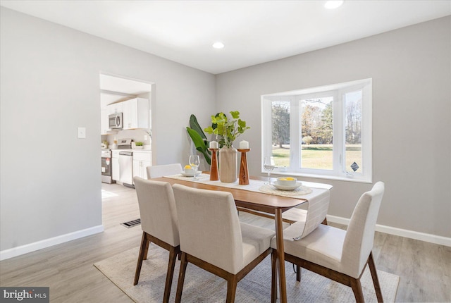 dining room with light wood-type flooring