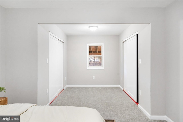 bedroom featuring light colored carpet