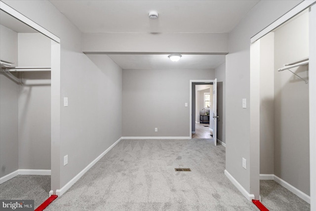 unfurnished bedroom featuring light carpet