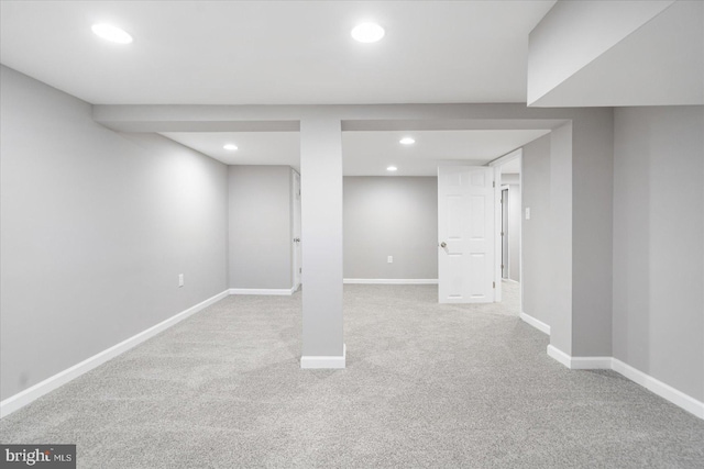 basement featuring light colored carpet