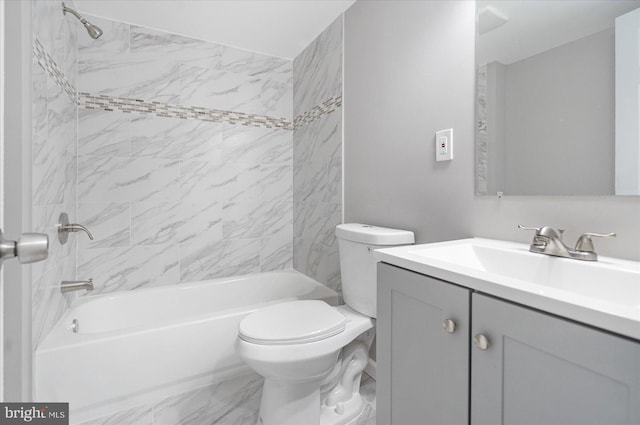 full bathroom with vanity, tiled shower / bath combo, and toilet