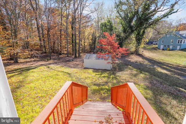 view of yard with a storage shed and a wooden deck