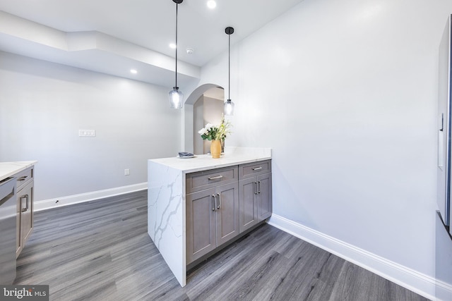 kitchen with dishwasher, dark hardwood / wood-style floors, pendant lighting, and kitchen peninsula