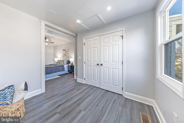 unfurnished bedroom with dark wood-type flooring and a closet