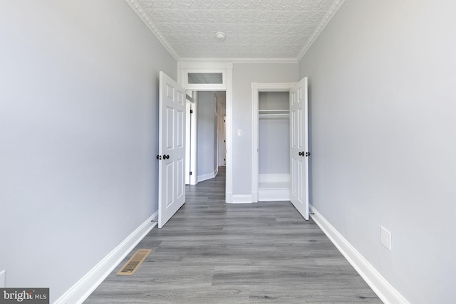 interior space featuring ornamental molding and hardwood / wood-style floors