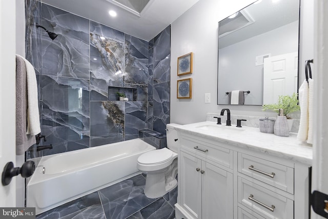 full bathroom with vanity, tiled shower / bath combo, and toilet