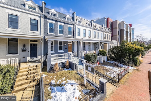 townhome / multi-family property with a porch