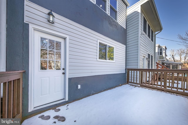 view of exterior entry with a wooden deck