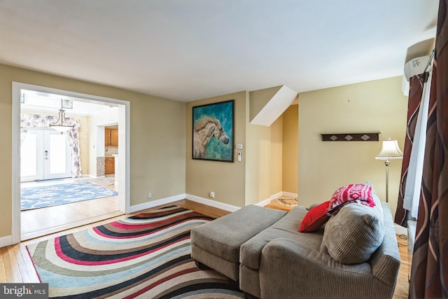 living room featuring french doors and light hardwood / wood-style flooring