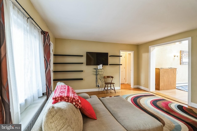 living room with baseboard heating and light wood-type flooring