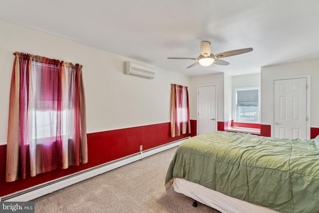 bedroom featuring a baseboard radiator, an AC wall unit, carpet, and ceiling fan