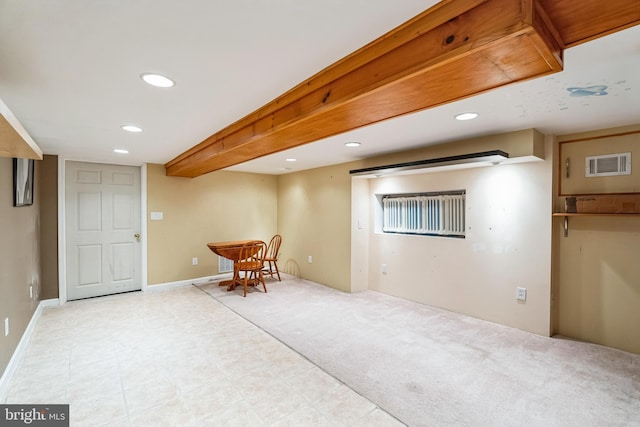 basement featuring light colored carpet