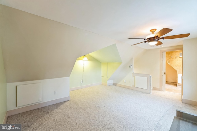 additional living space with lofted ceiling, ceiling fan, and carpet flooring