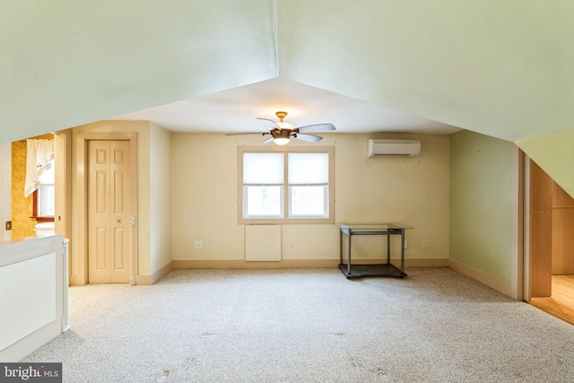 bonus room with light carpet, a wall mounted air conditioner, and ceiling fan