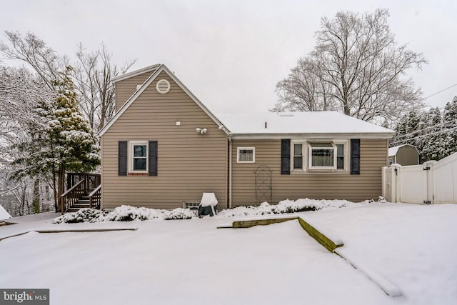 view of snow covered rear of property