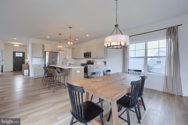 dining room featuring recessed lighting, a wealth of natural light, and light wood-style floors