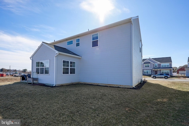 back of house featuring a lawn