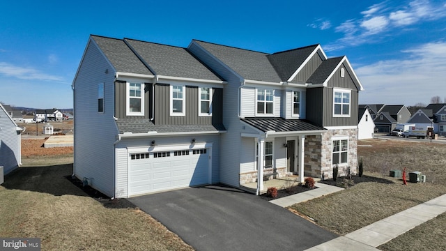 multi unit property featuring stone siding, a residential view, aphalt driveway, roof with shingles, and an attached garage