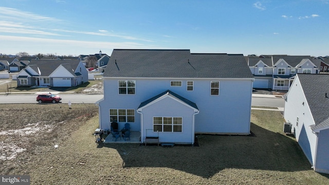 rear view of house featuring central air condition unit, a patio area, and a residential view