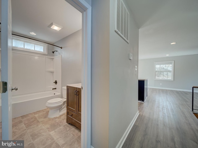 full bathroom with plenty of natural light, visible vents, toilet, bathtub / shower combination, and vanity