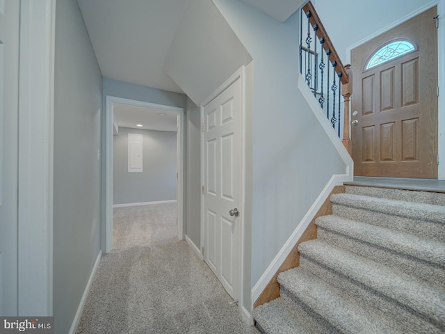 stairway featuring carpet and baseboards