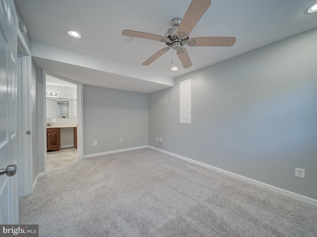 unfurnished bedroom with light carpet, recessed lighting, ensuite bath, and baseboards