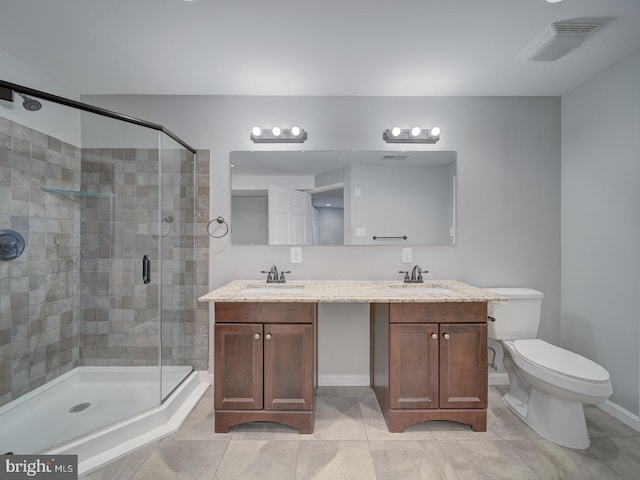 bathroom with visible vents, a sink, a shower stall, and toilet