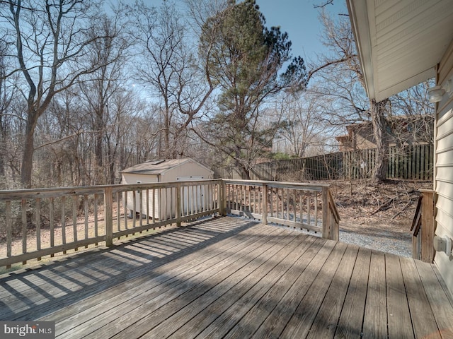 wooden terrace with a fenced backyard