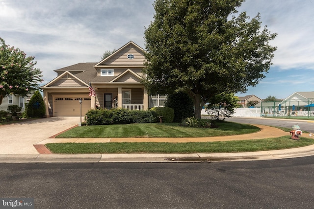 view of front facade with a garage, a front yard, and a porch