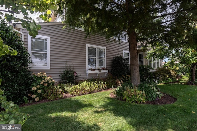 view of side of property with a lawn