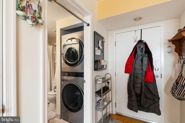 clothes washing area with laundry area and stacked washer / dryer