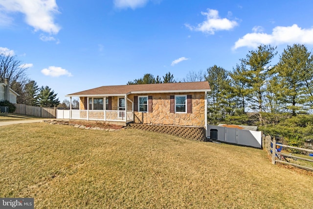 ranch-style house with stone siding, a front lawn, fence, and a gate