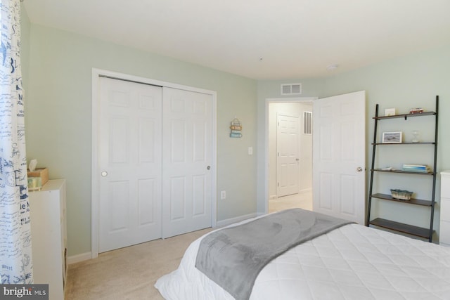 bedroom with light carpet and a closet