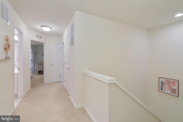 hallway with light carpet