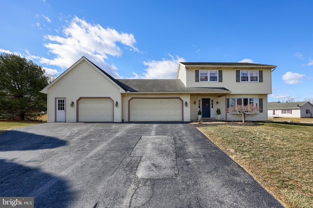 front facade featuring a front lawn and a garage