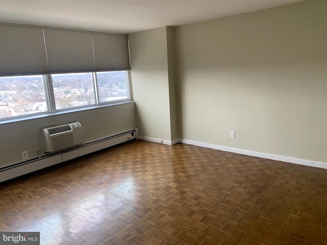 empty room with baseboards, baseboard heating, and a wall mounted air conditioner