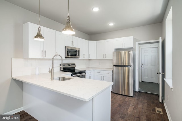 2941 Cecil B Moore Ave, Philadelphia, PA 19121 - kitchen with stainless steel appliances, a peninsula, backsplash, white cabinetry, and recessed lighting