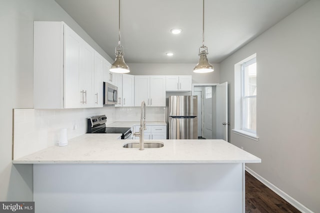 2941 Cecil B Moore Ave, Philadelphia, PA 19121 - kitchen with stainless steel appliances, a peninsula, tasteful backsplash, dark wood-style flooring, and white cabinetry